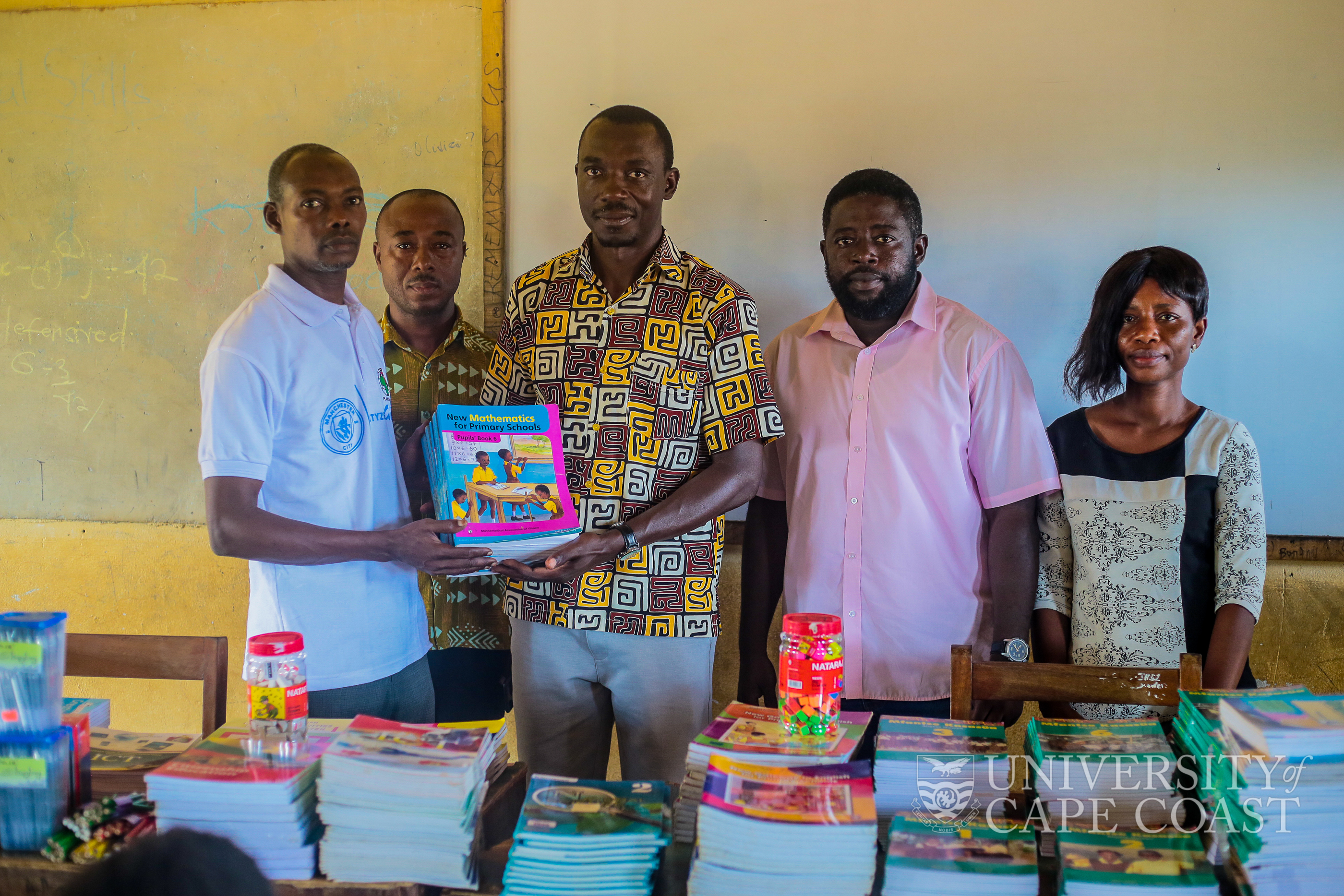 CEO-Tacoma Education Foundation, Dr. Benjamin Aboagye making the presentation to head teacher of the School, Mr. Abubakar Tijjani