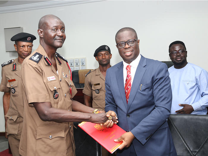 The Vice-Chancellor, Prof. Joseph Ghartey Ampiah, exchanging the signed MoU with the Chief Fire Officer, Mr. Edwin Ekow Blankson The Vice-Chancellor, Prof. Joseph Ghartey Ampiah, exchanging the signed MoU